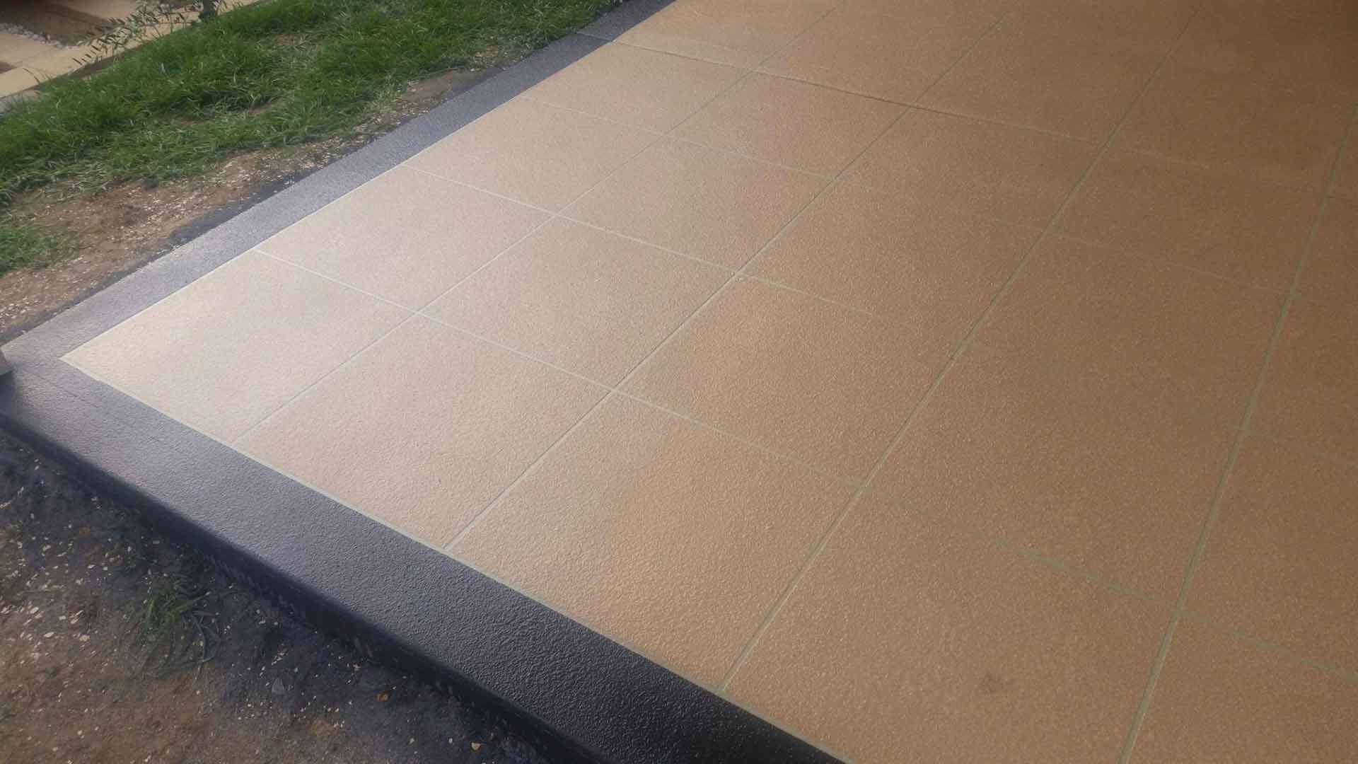 A Close Up Of A Tiled Floor With A Black Border — Custom Concrete Finishes In Killara, NSW