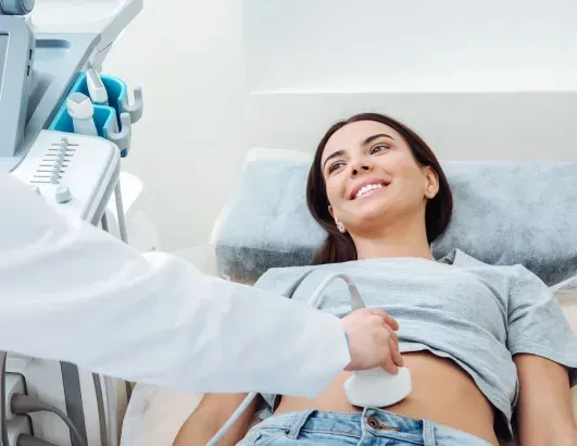 A woman is getting an ultrasound from a doctor.