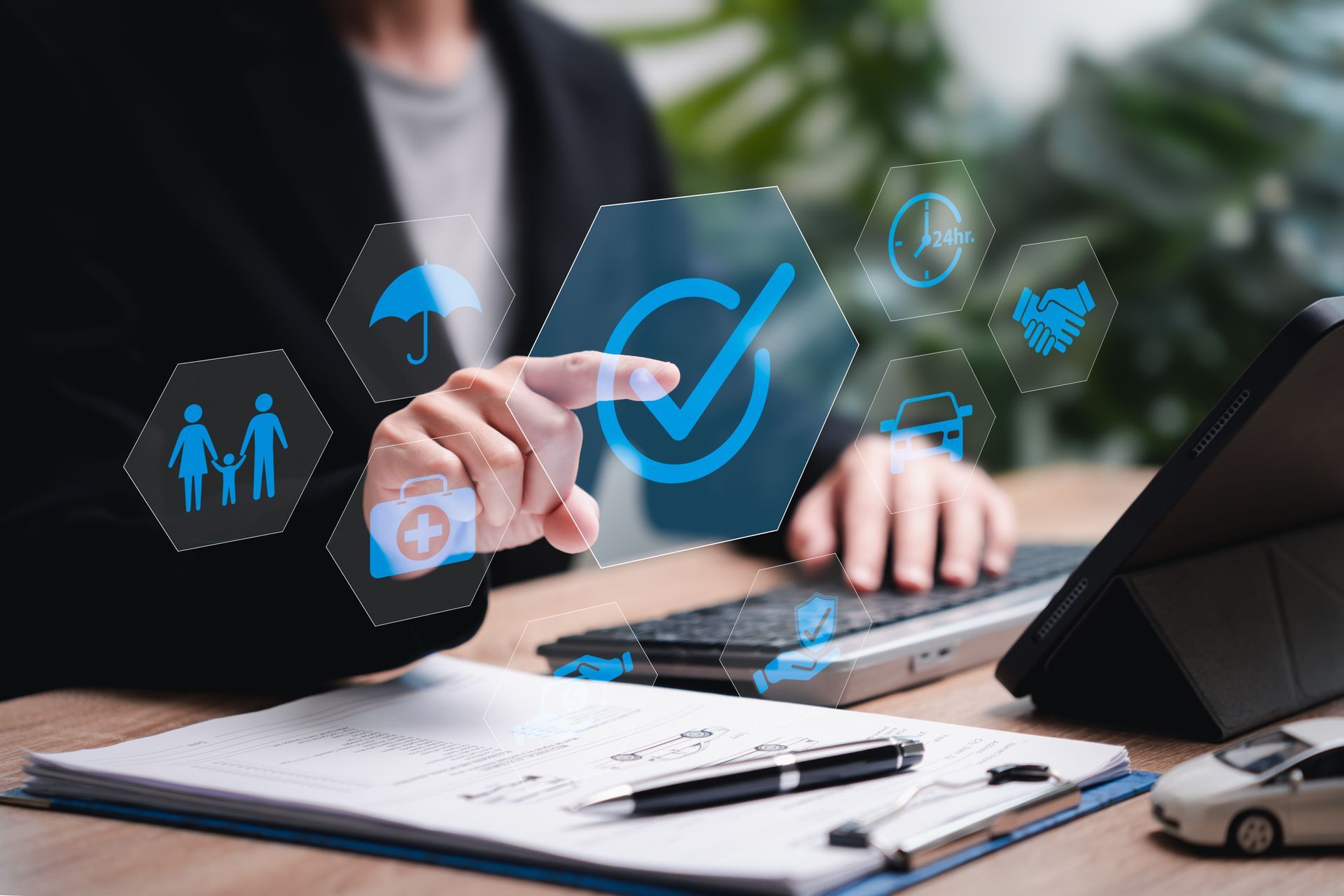 Person reviewing insurance coverage options with digital protection icons. Person reviewing insurance coverage options with digital protection icons.