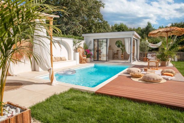 Large swimming pool in the backyard of a house.