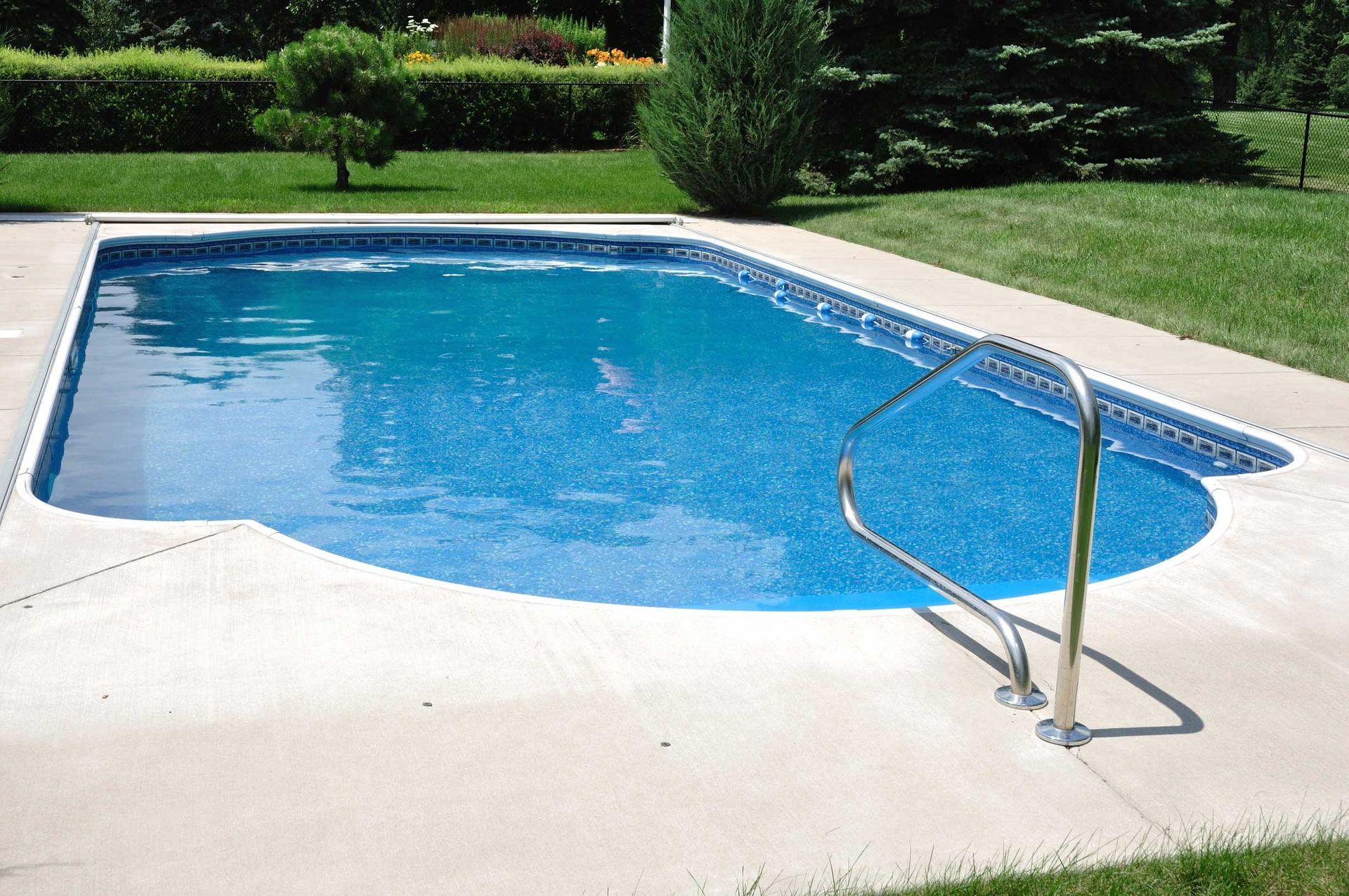 A large swimming pool with a staircase leading to it