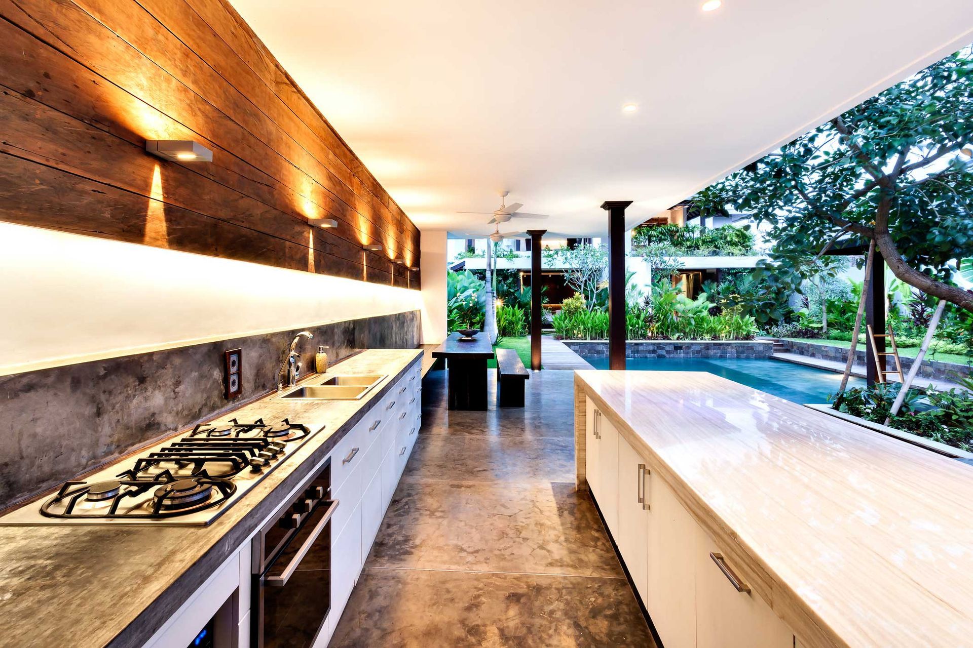 A kitchen with a stove top oven and a sink