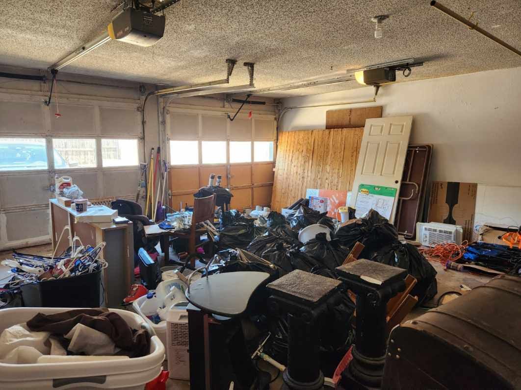A garage filled with lots of trash and boxes.