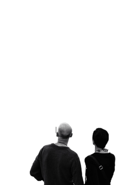 A man and a woman watching a video with bats flying towards them