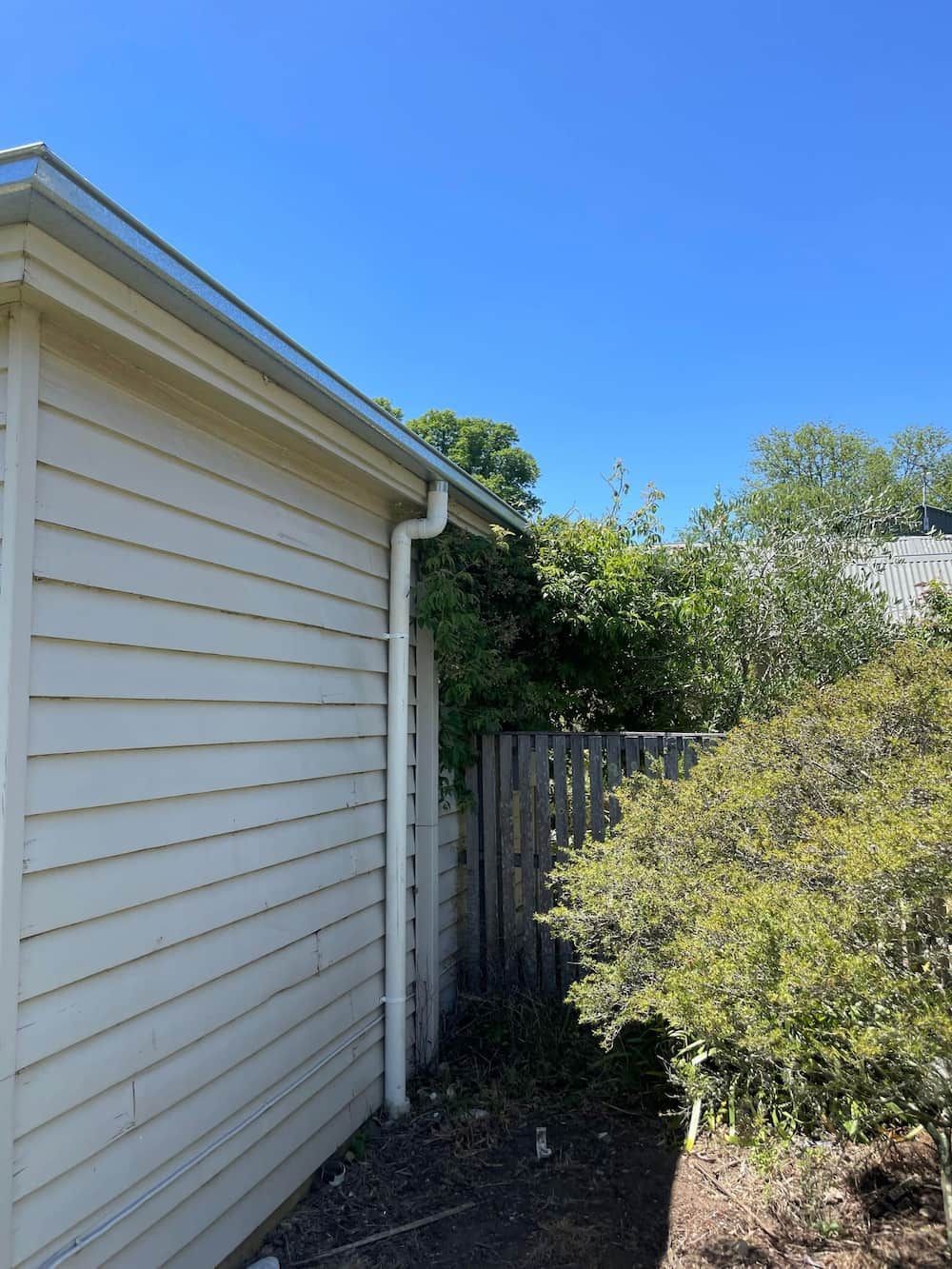 A White House With a Gutter on the Side of It — iFix Roofing Bendigo in Bendigo, VIC