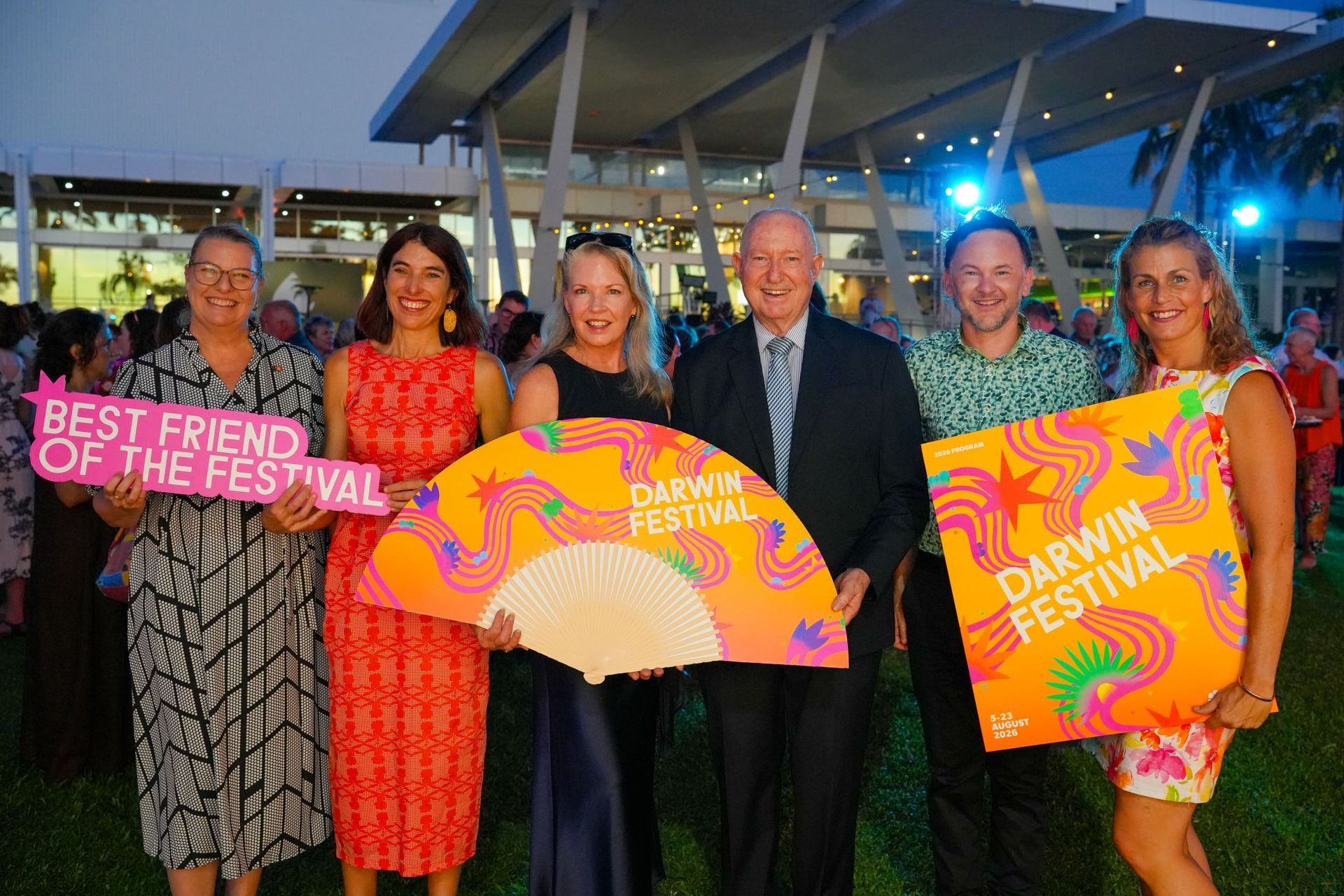 Five people holding Best Friend of the Festival and Darwin Festival signs at an outdoor event