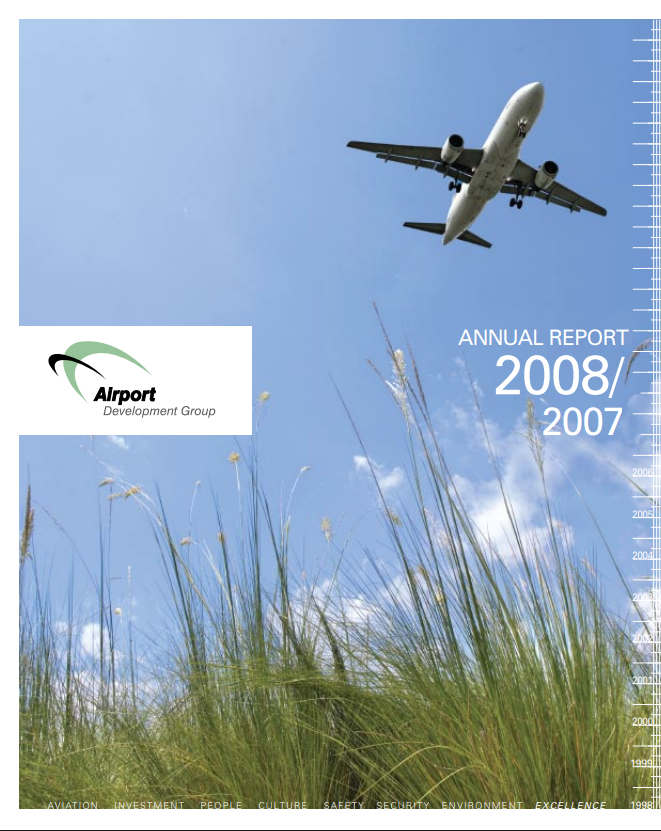 Annual report cover: Airplane landing over green grass and blue sky.
