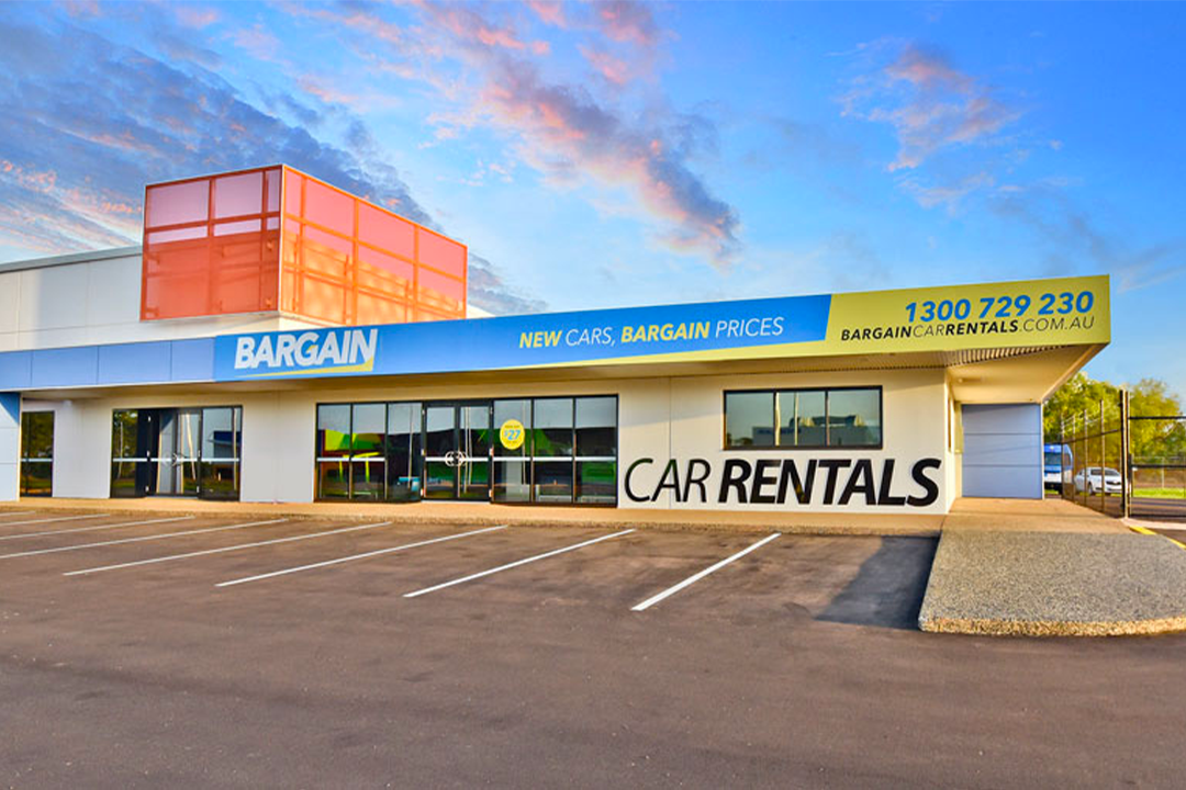 A parking lot outside Bargain Car Rentals.