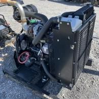 A industrial diesel engine with a radiator and metal safety grill, mounted on a steel base frame outdoors.