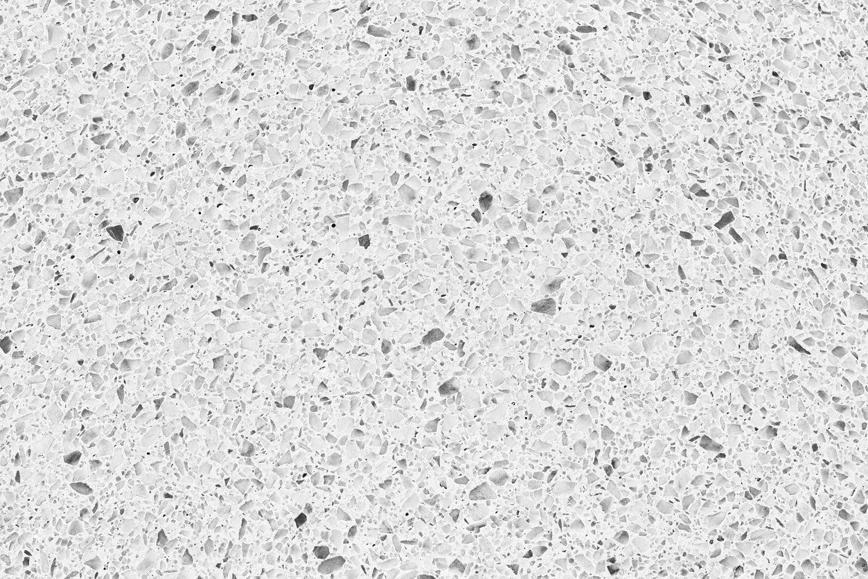 Close-up of a white quartz countertop with small, speckled aggregate.