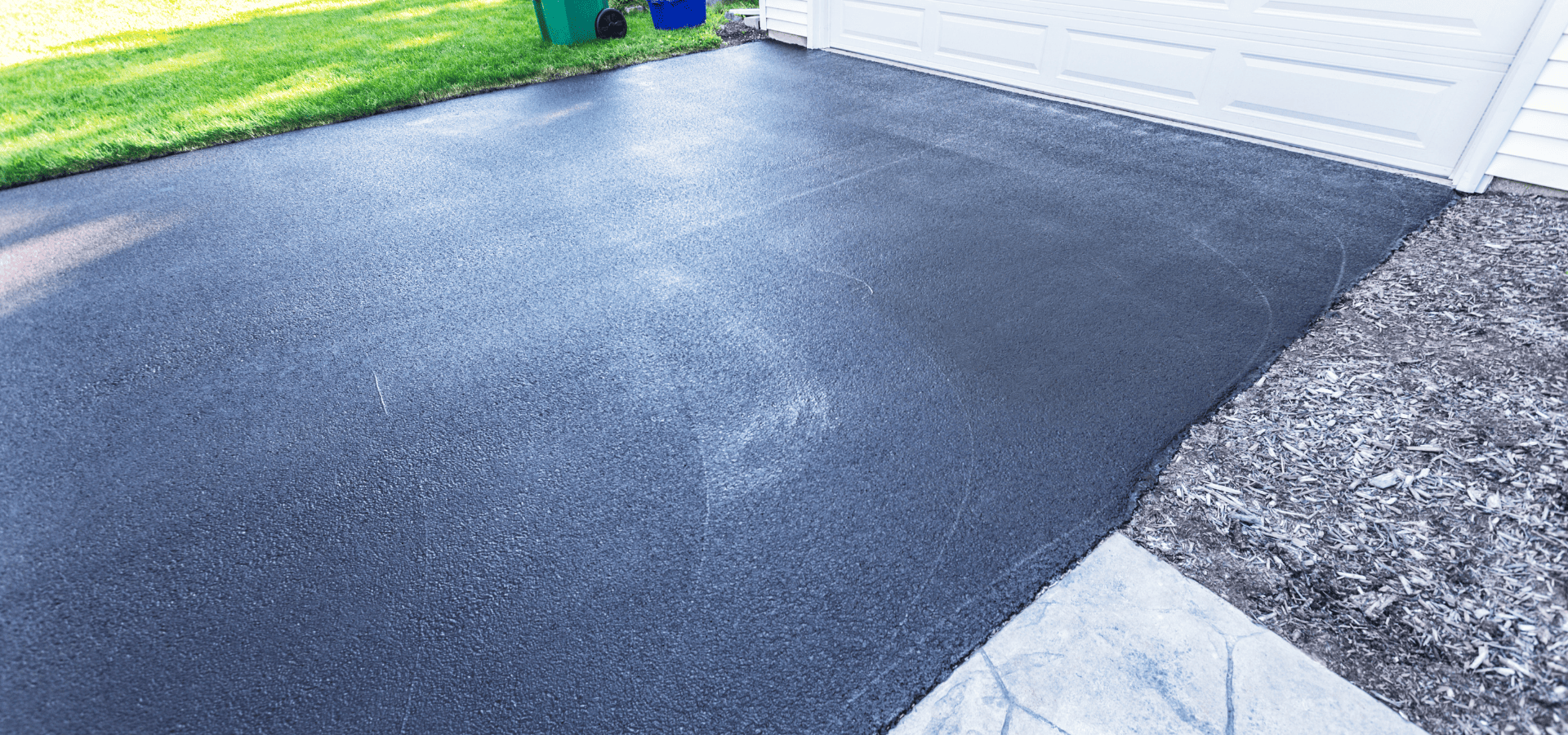 Freshly sealed black asphalt driveway