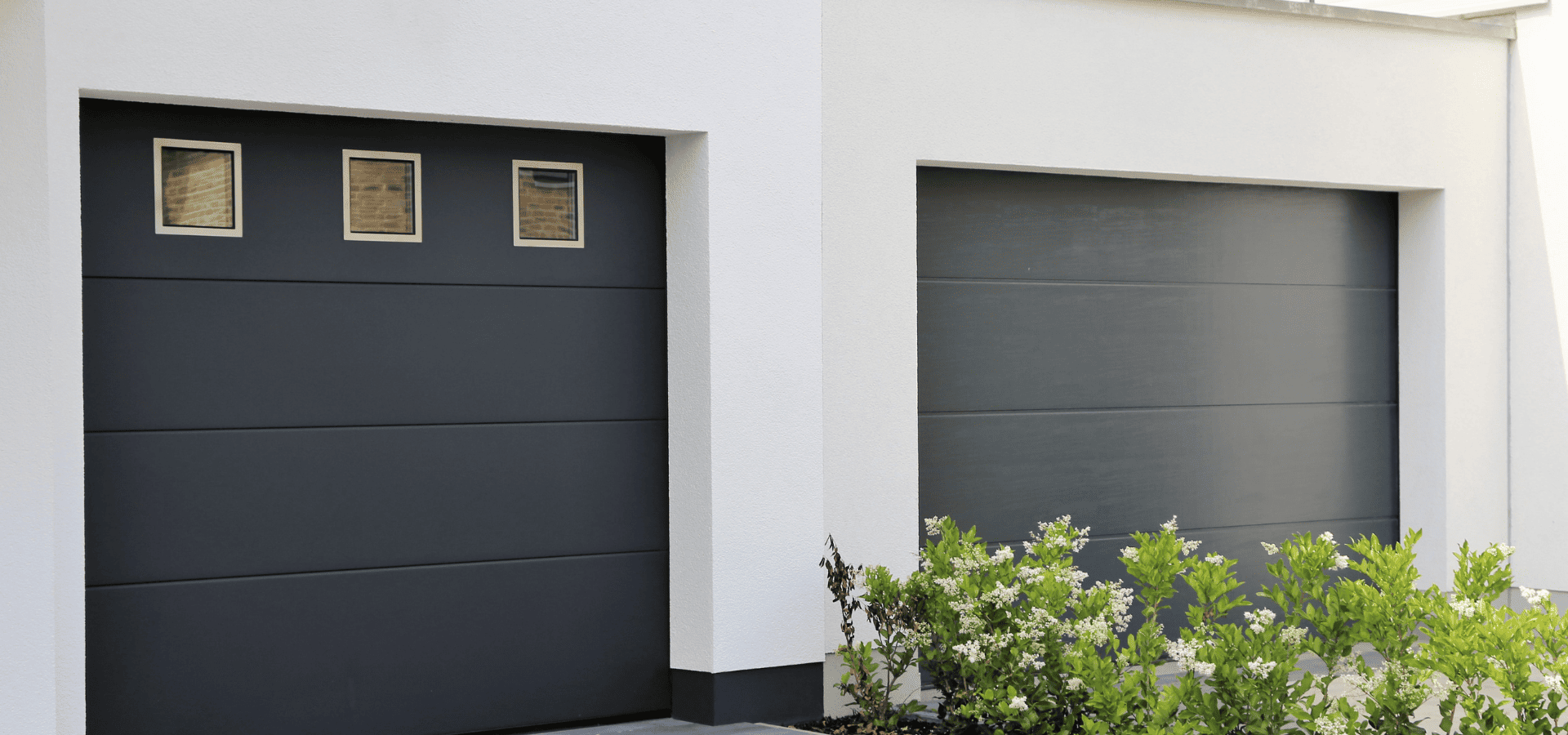 Two modern black painted garage doors in a modern home
