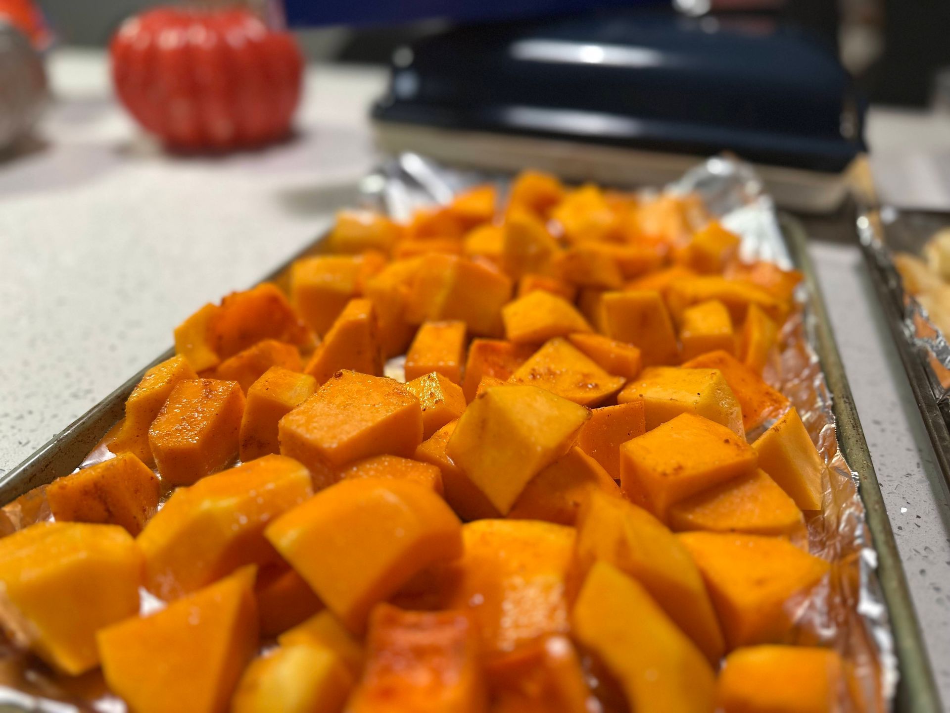 a tray of sliced sweet potatoes ready for roasting