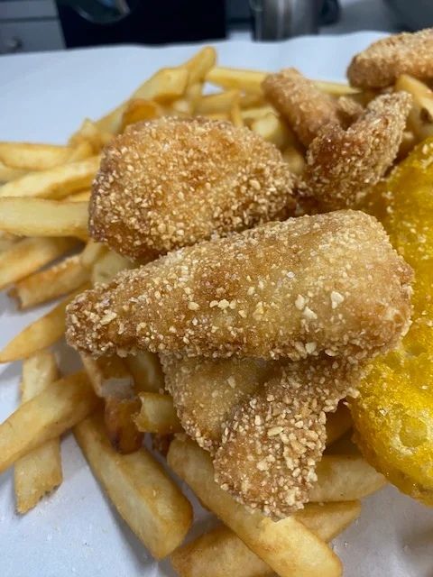 A Close Up of Fried Fish and French Fries on a Plate — Cedar Park Fish & Chips In Taranganba, QLD