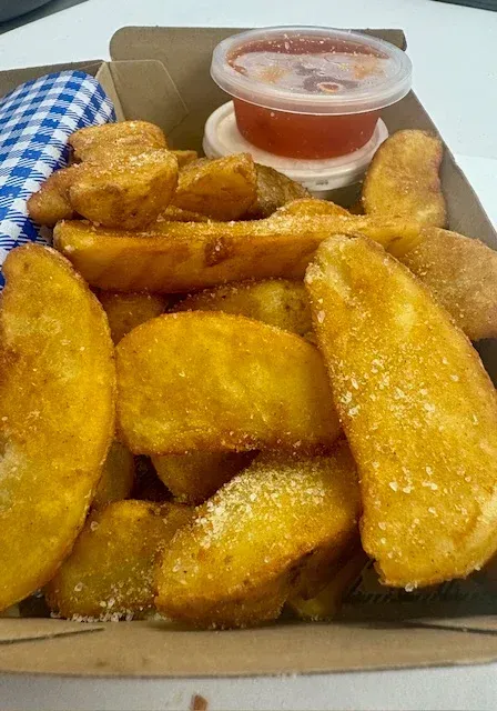 A Box of French Fries With Dipping Sauce on a Table — Cedar Park Fish & Chips In Taranganba, QLD