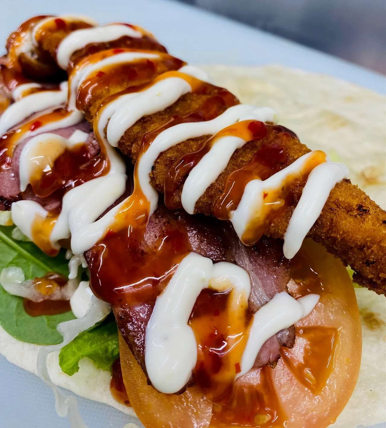 A Close Up of a Chicken Wrap With Sauce and Mayonnaise — Cedar Park Fish & Chips In Taranganba, QLD