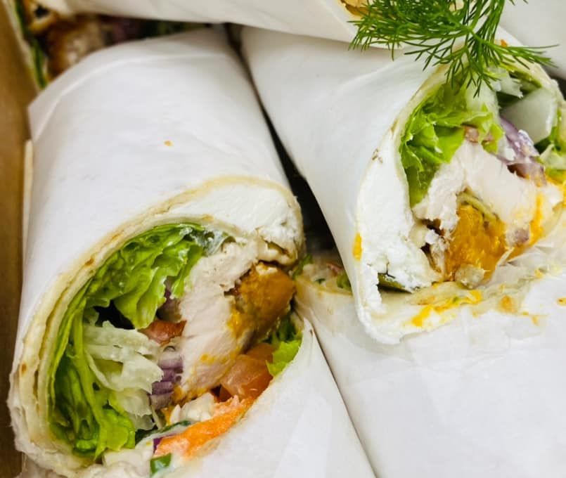 A Close Up of a Wrap With Lettuce and Chicken — Cedar Park Fish & Chips In Taranganba, QLD