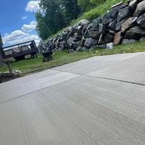 A Gray House with A Concrete Driveway and A Lush Green Lawn | Altoona, WI | Xtreme Klean
