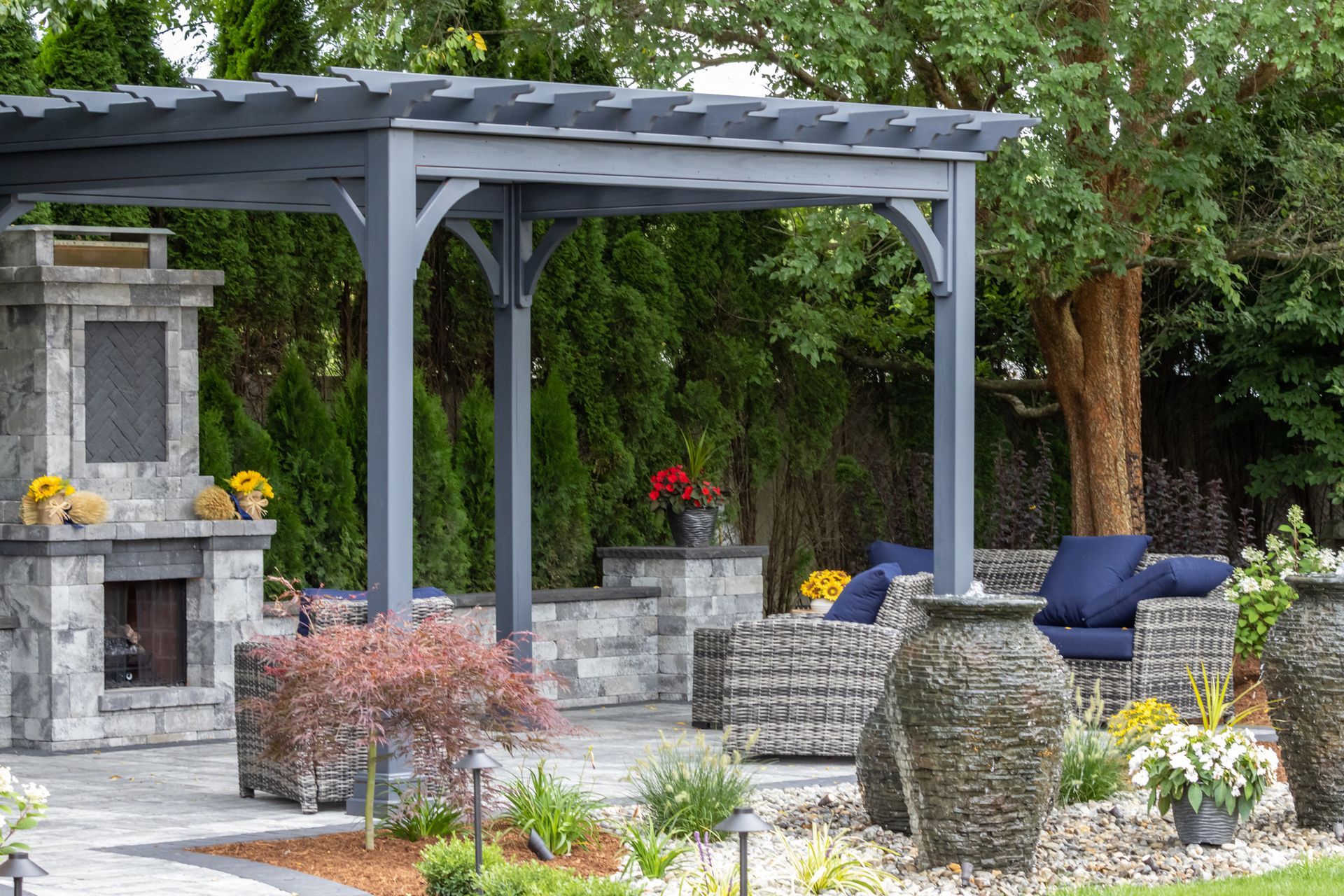A Patio with A Pergola and A Fireplace in The Backyard | Altoona, Wi | Xtreme Klean
