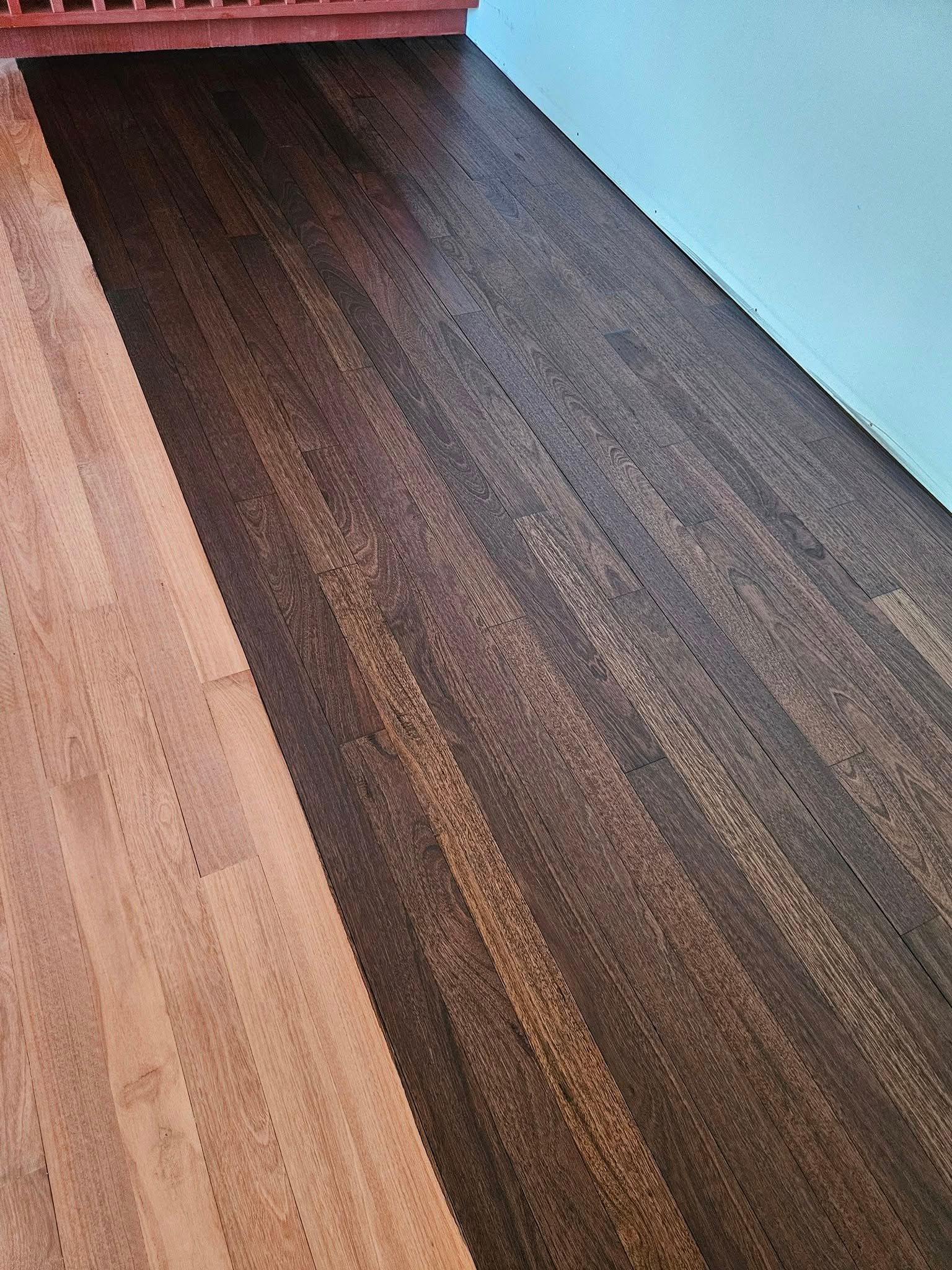 A close up of a wooden floor in a room.