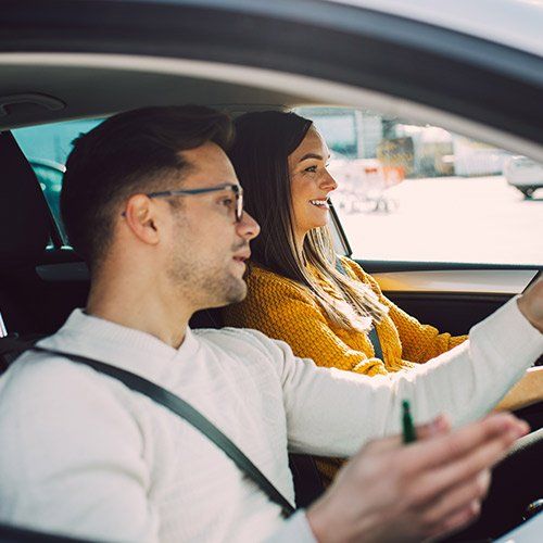 an instructor teaching a woman how to drive