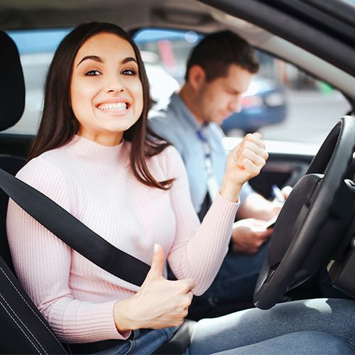an instructor teaching a woman how to drive