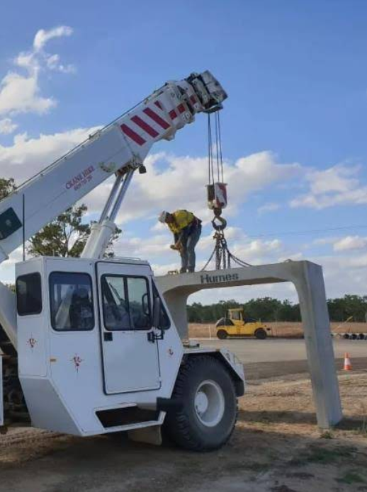 A Worker Supervising A Crane Lifting A Load Of Metal Barriers— Mareeba Crane Hire In Mareeba, QLD