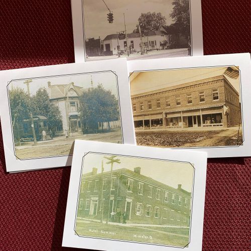Four vintage photo postcards of old buildings arranged on a red textured background.