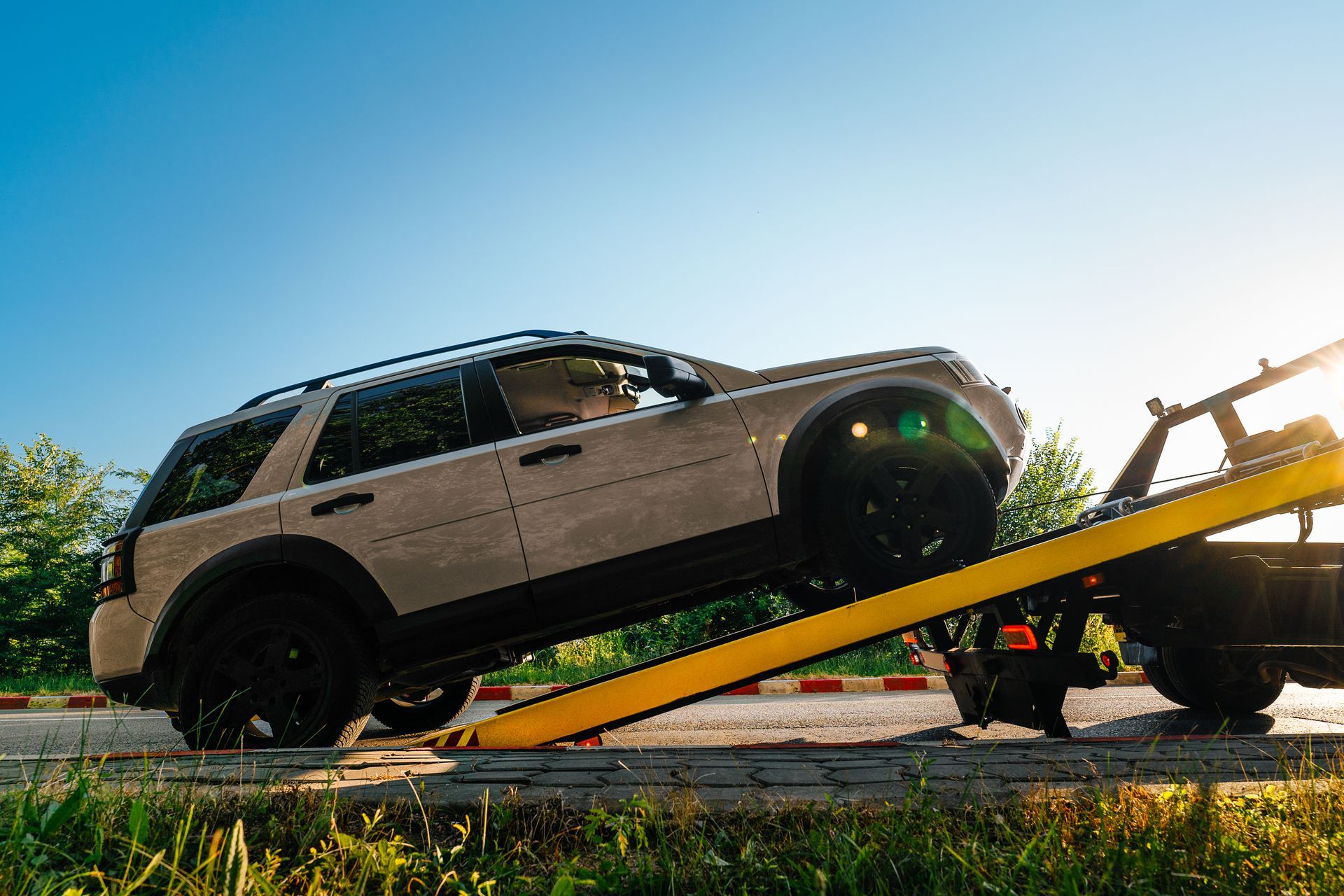 Vehicle being loaded onto a tow truck after a roadside breakdown. Vehicle being loaded onto a tow truck after a roadside breakdown.