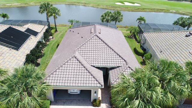 An aerial view of a house with a car parked in the garage.