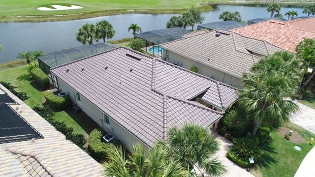 An aerial view of a row of houses next to a body of water.