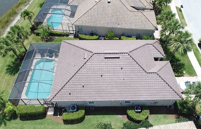 An aerial view of a house with a pool in the backyard.