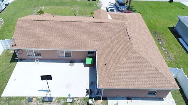 An aerial view of a house with a brown roof.
