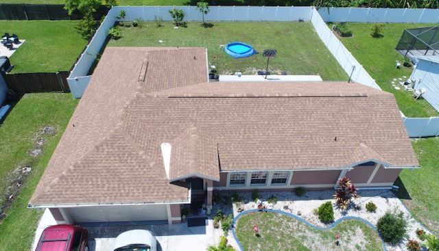 An aerial view of a house with a car parked in front of it.