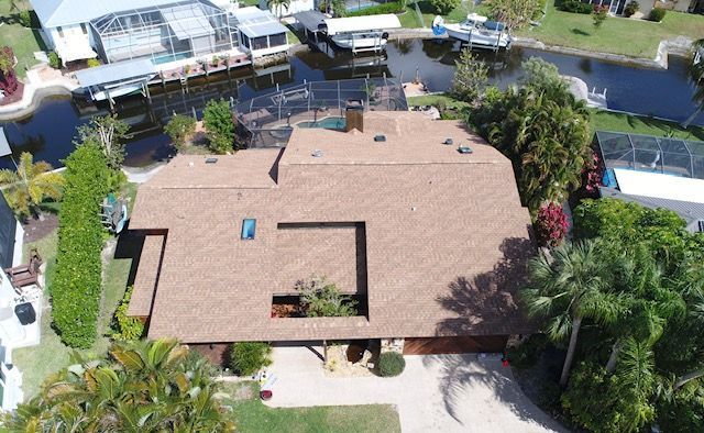 An aerial view of a house with a roof that is covered in shingles.