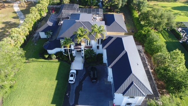 An aerial view of a house with a car parked in front of it