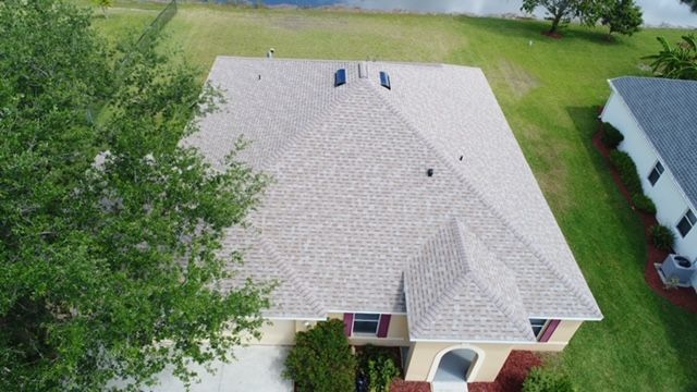 An aerial view of a house with a new roof.