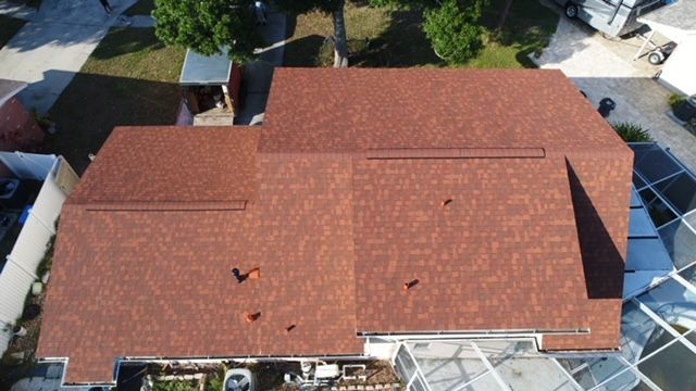 An aerial view of a house with a red roof.