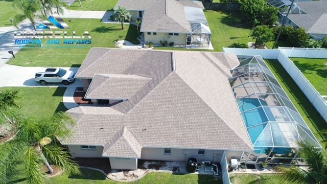 An aerial view of a house with a pool in the backyard