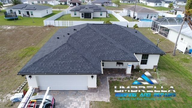 An aerial view of a house with a black roof