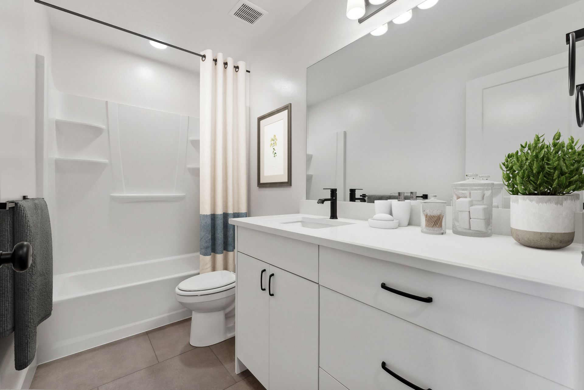 Bright modern bathroom with white vanity, toilet, tub, and shower shelves townhomes for rent Ogden Utah Madison Towns on 40th
