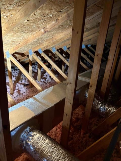An industrial HVAC unit with two pleated filters sits inside a utility closet with light-colored walls and carpet.