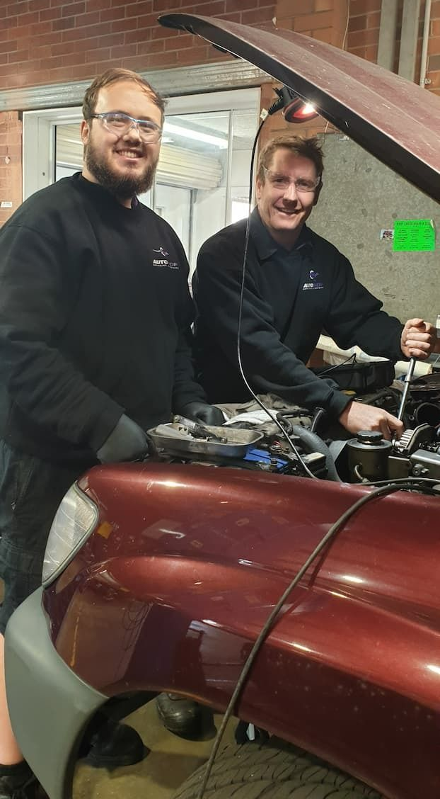 Two Mechanics Working on A Car Engine in A Garage — AutoHop Lambton in Lambton, NSW