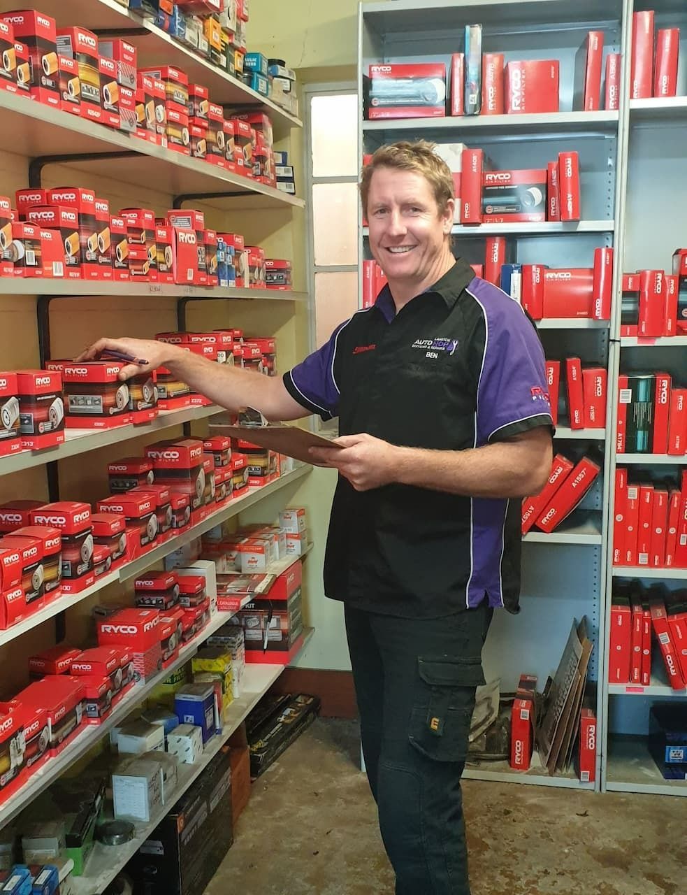 Man in A Store Reaching for A Product — AutoHop Lambton in Lambton, NSW