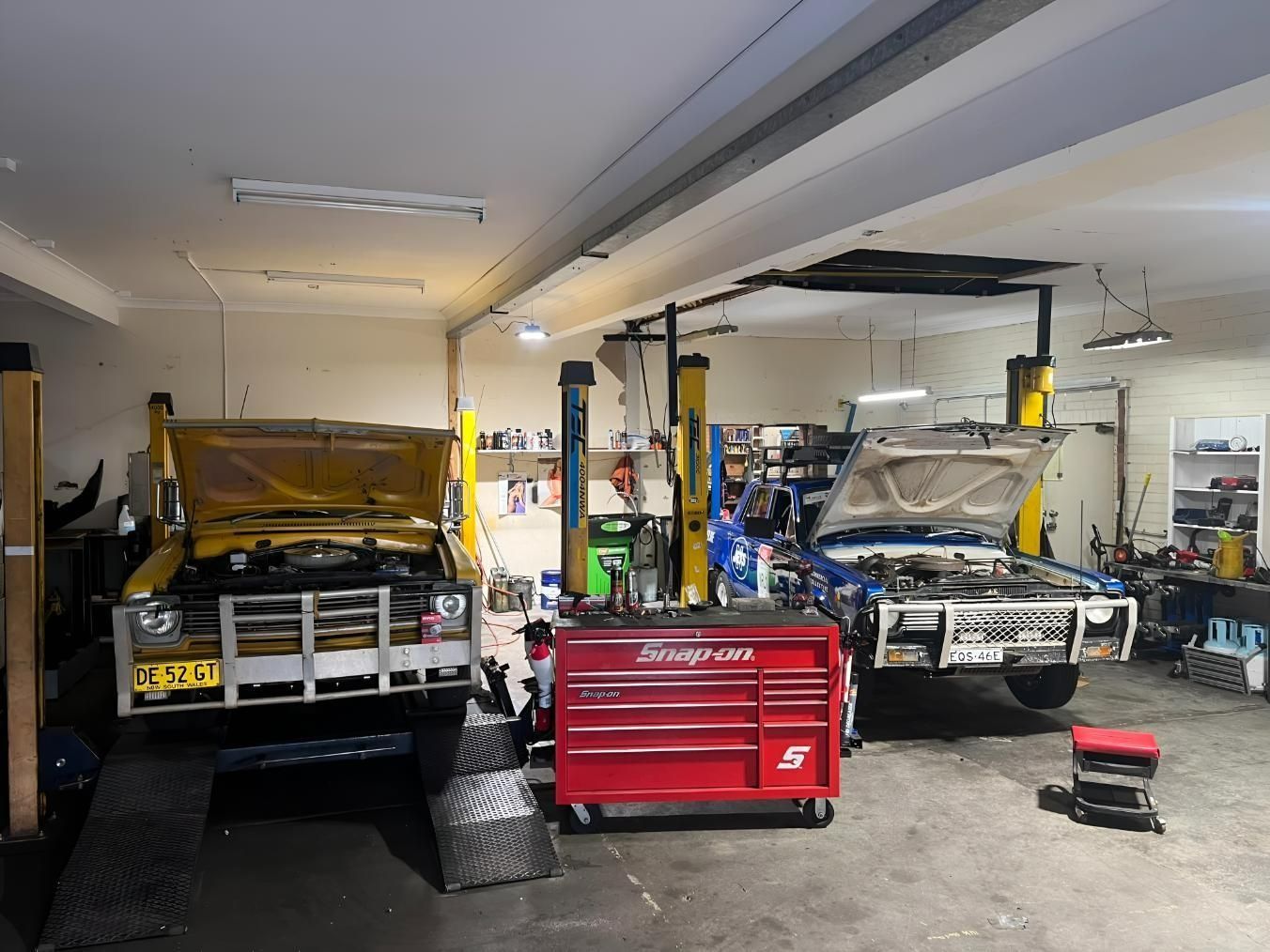 Two Cars on Lifts in the AutoHop Lambton workshop with A Red Toolbox — AutoHop Lambton in Lambton, NSW