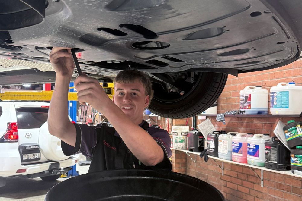 Vehicle on A Lift Being Checked by Mechanic