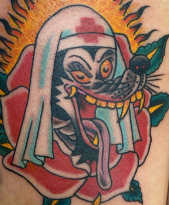 Traditional American wolf nurse, and rose tattoo done by Rylee Jennings
