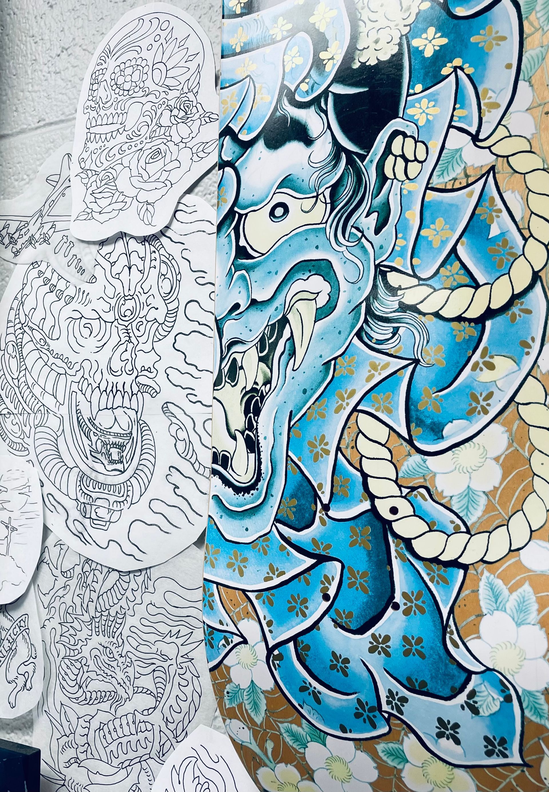 Tattooing designs and a Hanya skateboard deck at Classic Tattoo