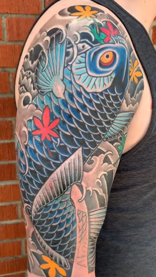 Traditional Japanese arm sleeve completed by Nick Barnett of a koi swimming up a waterfall
