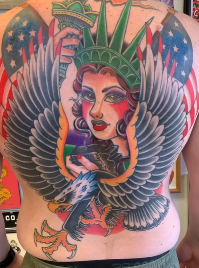A large lady liberty, and eagle with American flags backpiece completed by Nick Barnett